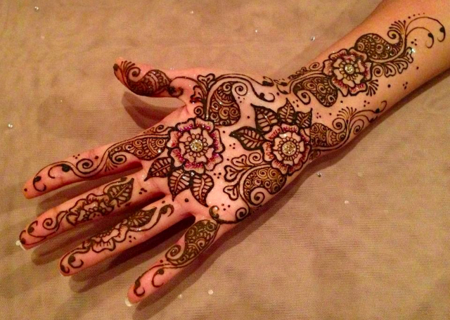 Bridal Mehandi Design featuring multiple patterns highlighted with glitter