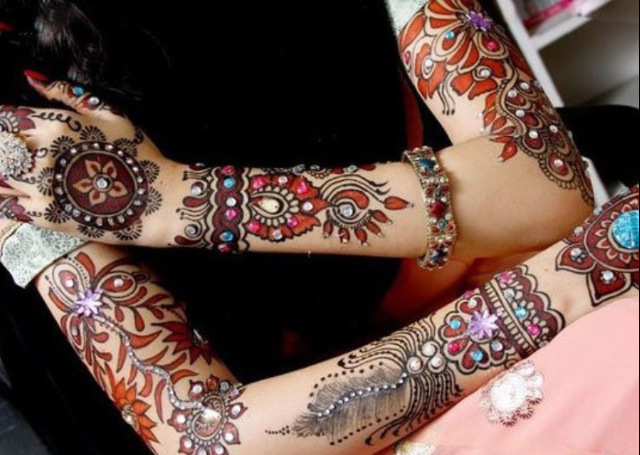 Latest Arabic Mehandi Design with colored stones and bold patterns on arms