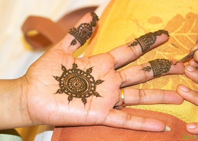 Latest Simple Mehandi Design with traditional wheel patterns